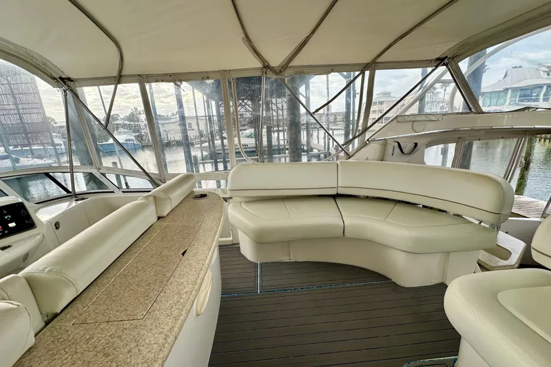Slide: The Image of 2005 Silverton 43 Motor Yacht interior with elegant seating and panoramic marina view. - 12