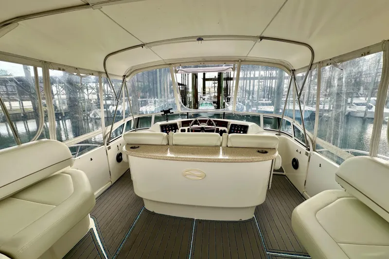 Slide: The Image of Interior view of a 2005 Silverton 43 Motor Yacht with helm and seating area. - 13