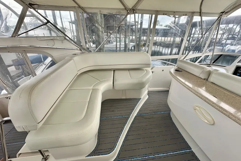 Slide: The Image of 2005 Silverton 43 Motor Yacht interior with white seating and panoramic windows. - 14