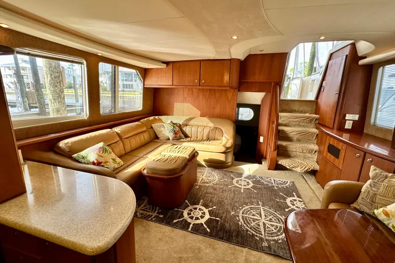 Slide: The Image of Luxurious interior of a 2005 Silverton 43 Motor Yacht with plush seating and elegant decor. - 16
