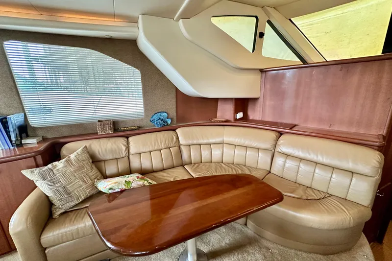 Slide: The Image of Luxurious interior of 2005 Silverton 43 Motor Yacht with leather seating and wooden table. - 20