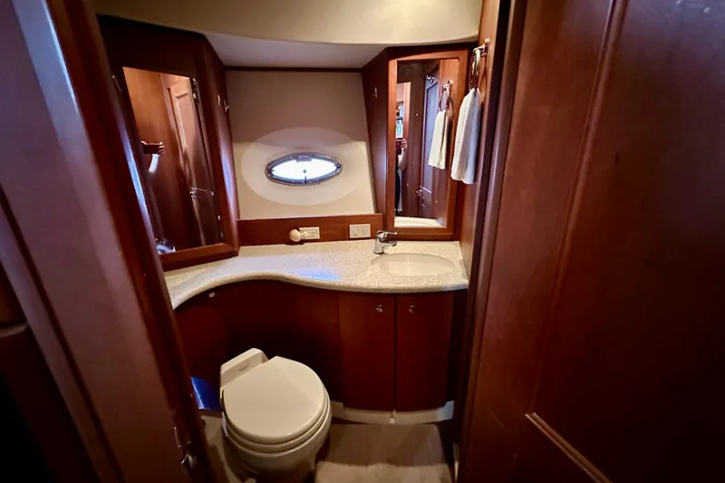Slide: The Image of 2005 Silverton 43 Motor Yacht bathroom with wooden cabinetry and modern fixtures. - 22