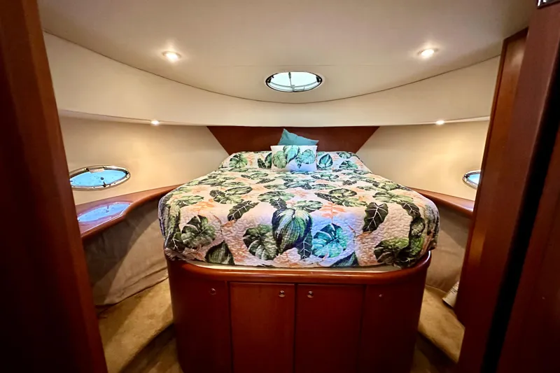Slide: The Image of Luxurious bedroom in 2005 Silverton 43 Motor Yacht with floral bedding and elegant lighting. - 23