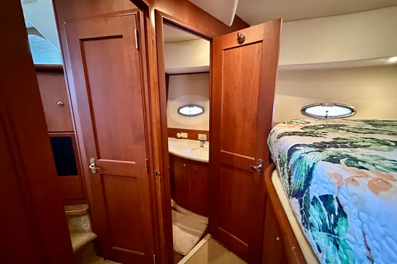Slide: The Image of Interior of 2005 Silverton 43 Motor Yacht with wood cabinetry and cozy bedding. - 24