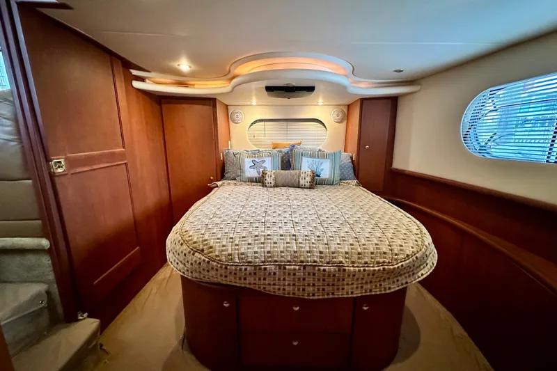 Slide: The Image of Luxurious bedroom interior of 2005 Silverton 43 Motor Yacht with elegant wood paneling. - 27