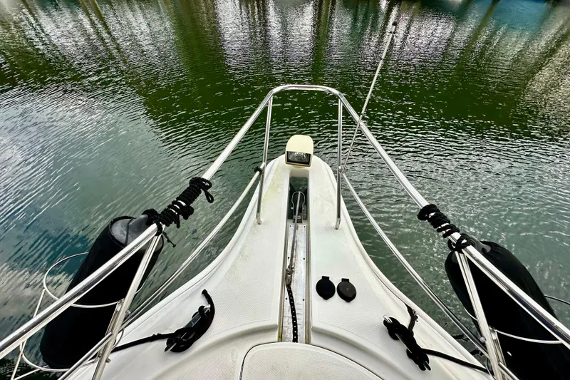 Slide: The Image of Bow view of 2005 Silverton 43 Motor Yacht on calm water. - 3