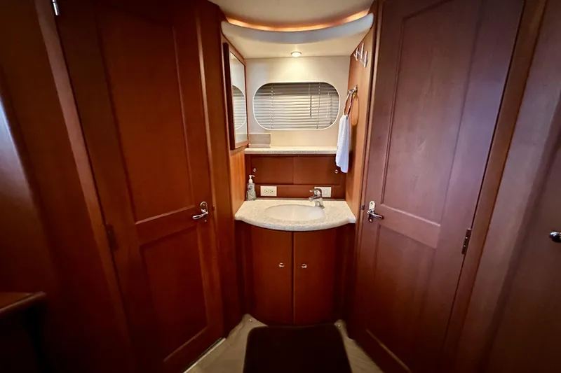 Slide: The Image of 2005 Silverton 43 Motor Yacht bathroom with wooden cabinetry and modern sink. - 32