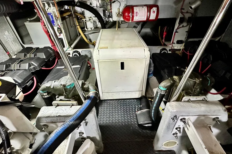 Slide: The Image of Engine room of a 2005 Silverton 43 Motor Yacht with equipment and fire extinguisher. - 34