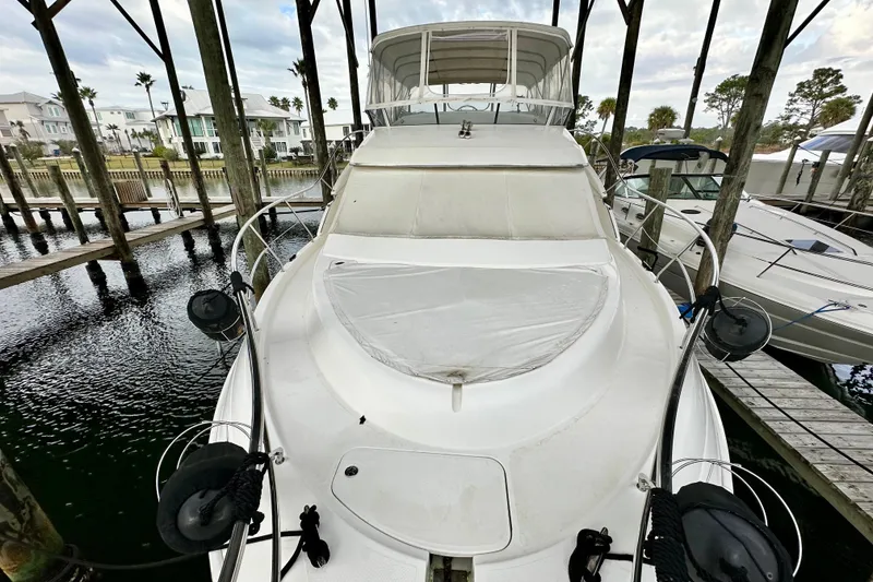 Slide: The Image of 2005 Silverton 43 Motor Yacht docked in a marina, covered and ready for use. - 4