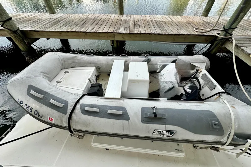 Slide: The Image of Inflatable dinghy on 2005 Silverton 43 Motor Yacht, docked by wooden pier. - 5