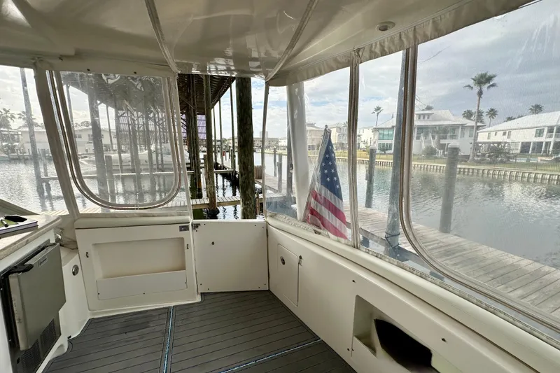 Slide: The Image of 2005 Silverton 43 Motor Yacht interior with dockside view and American flag. - 6