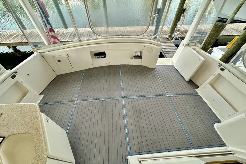 Slide: The Image of 2005 Silverton 43 Motor Yacht deck with spacious seating and water view. - 8