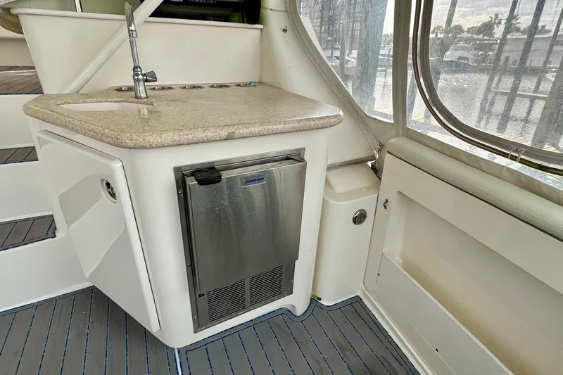 Slide: The Image of 2005 Silverton 43 Motor Yacht interior with kitchenette, sink, and mini fridge. - 9