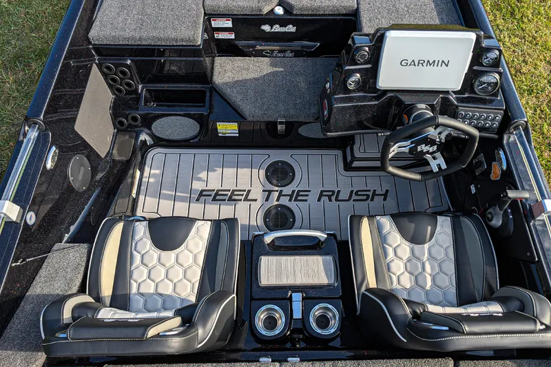 Slide: The Image of 2026 Bass Cat Eyra SP boat interior with Garmin system and "Feel the Rush" flooring. - 11