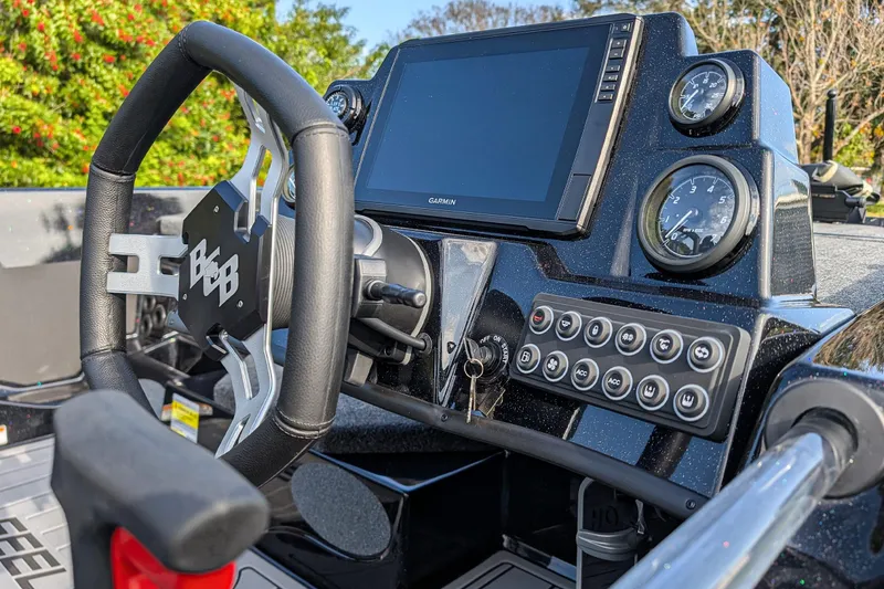 Slide: The Image of 2026 Bass Cat Eyra SP dashboard with steering wheel, gauges, and control panel. - 14