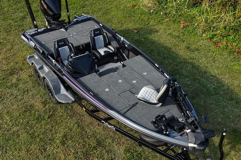 Slide: The Image of 2026 Bass Cat Eyra SP fishing boat on grass, showcasing sleek design and seating. - 8