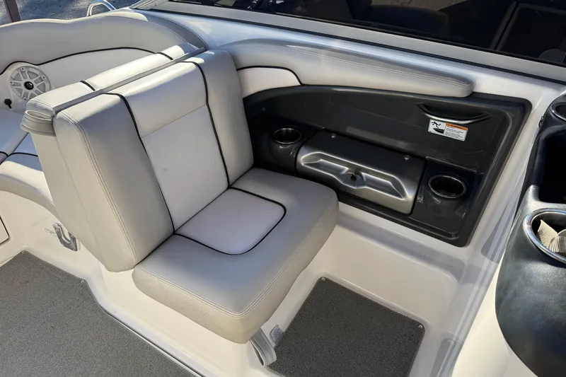 Slide: The Image of 2011 Yamaha Boats AR240 HO interior seating with cup holders and storage compartment. - 14