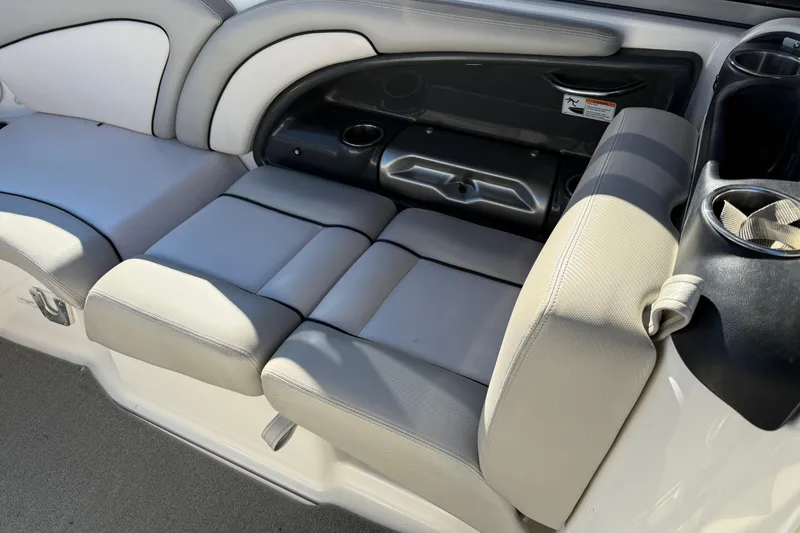 Slide: The Image of 2011 Yamaha Boats AR240 HO interior seating with cup holders and storage. - 15