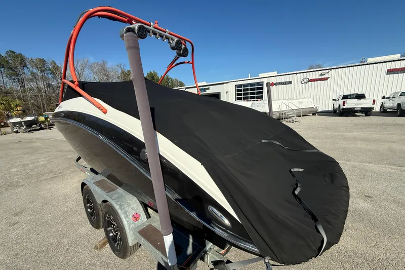 Slide: The Image of 2011 Yamaha Boats AR240 HO covered on trailer, parked outdoors. - 18