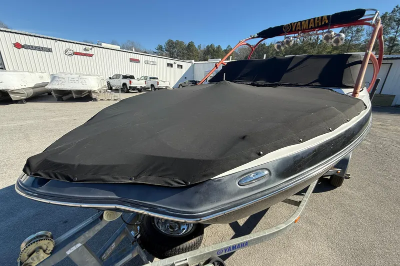 Slide: The Image of 2011 Yamaha Boats AR240 HO covered on trailer, parked outdoors. - 20