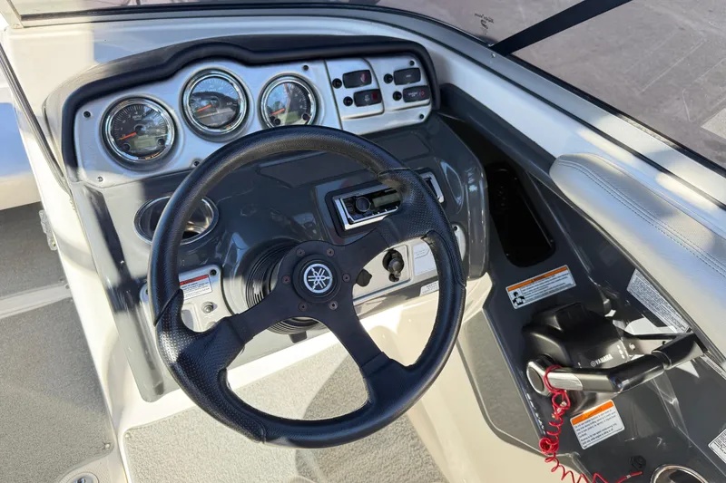 Slide: The Image of 2011 Yamaha Boats AR240 HO dashboard with steering wheel and control panel. - 8