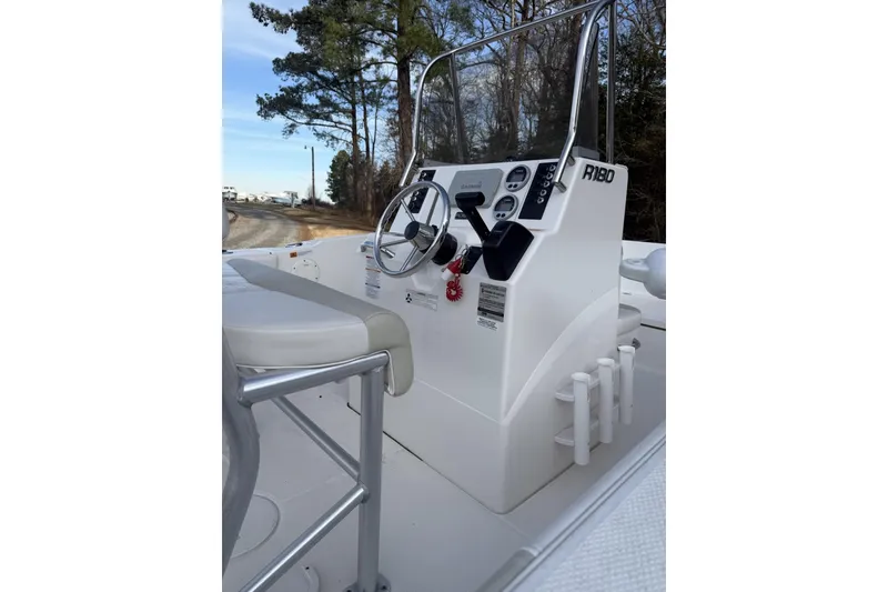 Slide: The Image of 2016 Robalo R180 Center Console boat interior with steering wheel and controls. - 3
