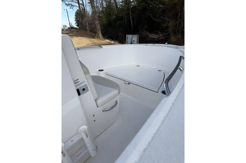 Slide: The Image of 2016 Robalo R180 Center Console boat interior with seating and storage. - 5