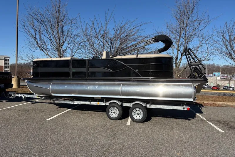 The Image of 2026 Bentley Pontoons Legacy 223 Navigator on trailer in parking lot. - 0