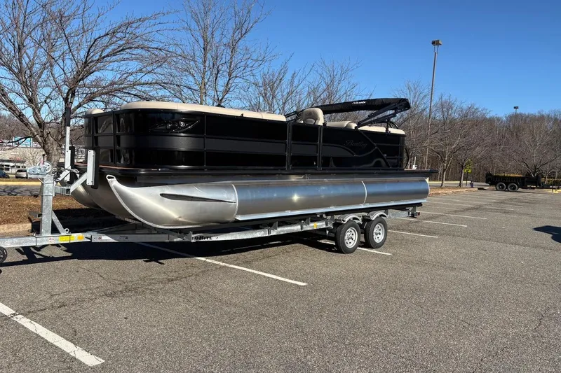 Slide: The Image of 2026 Bentley Pontoons Legacy 223 Navigator on trailer in parking lot. - 1