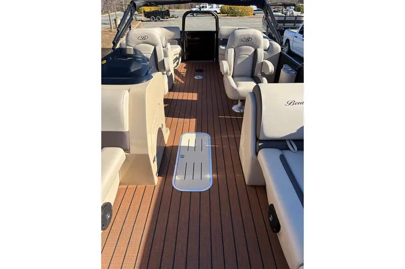 Slide: The Image of 2026 Bentley Pontoons Legacy 223 Navigator interior with luxurious seating and wood-style flooring. - 10