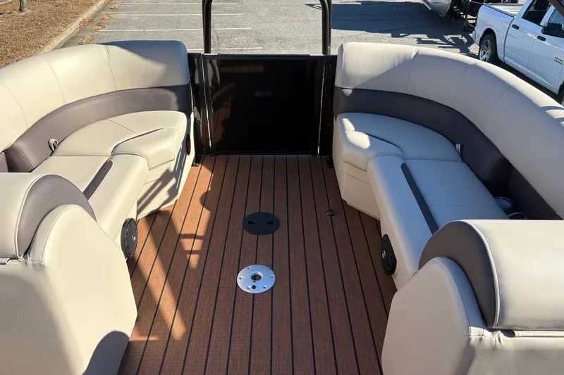 Slide: The Image of 2026 Bentley Pontoons Legacy 223 Navigator interior with luxurious seating and wood-style flooring. - 3