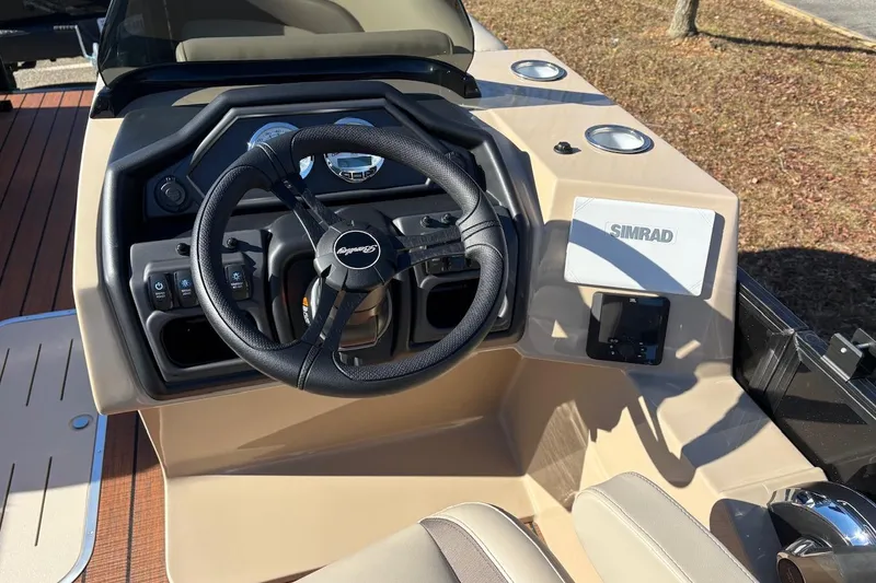 Slide: The Image of 2026 Bentley Pontoons Legacy 223 Navigator dashboard with steering wheel and Simrad display. - 5