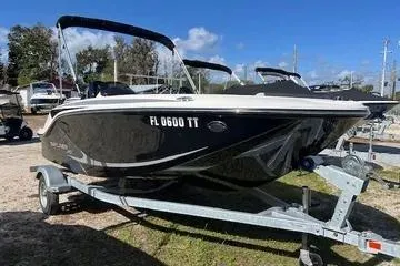 The Image of 2024 Bayliner Element M15 boat on trailer, black exterior, parked outdoors. - 0