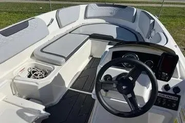Slide: The Image of 2024 Bayliner Element M15 boat interior with steering wheel and seating. - 3