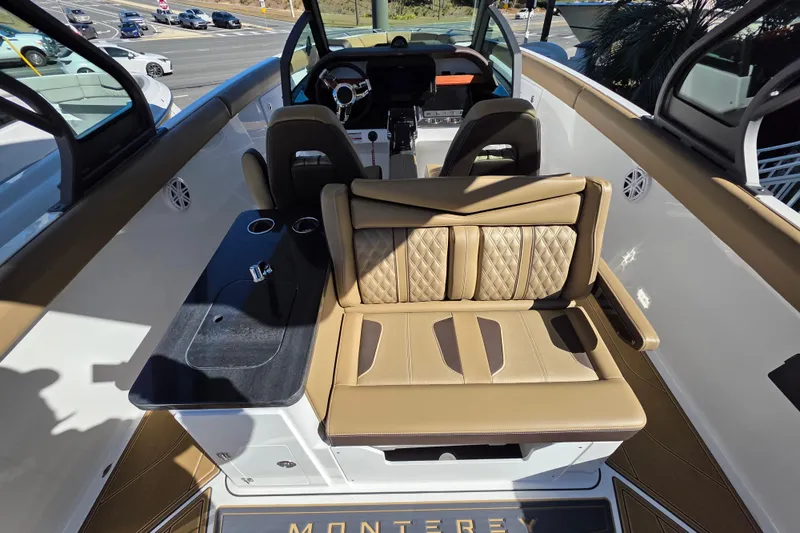 Slide: The Image of 2026 Monterey Elite 30 OB boat interior with luxurious seating and modern dashboard. - 10