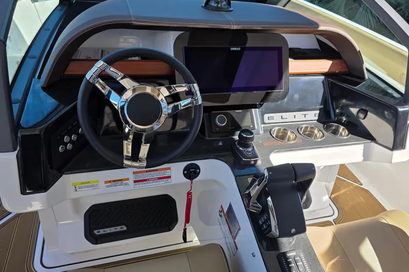 Slide: The Image of 2026 Monterey Elite 30 OB boat dashboard with steering wheel and control panel. - 12