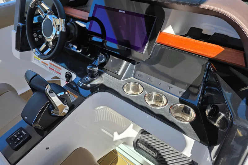 Slide: The Image of 2026 Monterey Elite 30 OB boat dashboard with modern controls and sleek design. - 13