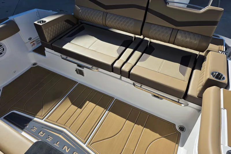 Slide: The Image of 2026 Monterey Elite 30 OB boat interior with luxurious seating and teak-style flooring. - 15