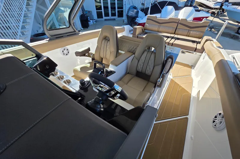 Slide: The Image of Luxurious interior of 2026 Monterey Elite 30 OB boat with plush seating and modern controls. - 16