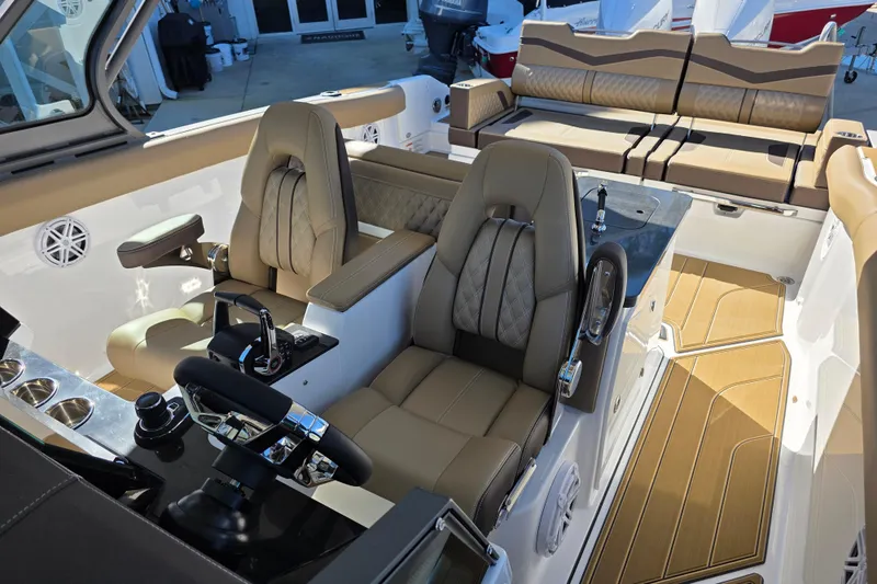 Slide: The Image of 2026 Monterey Elite 30 OB boat interior with luxurious seating and modern controls. - 17