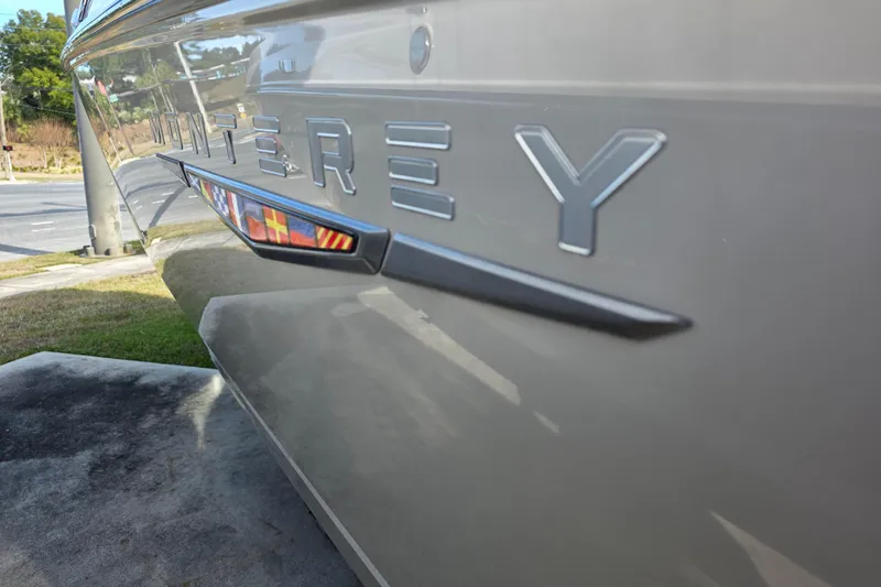 Slide: The Image of 2026 Monterey Elite 30 OB boat side view with logo detail. - 2