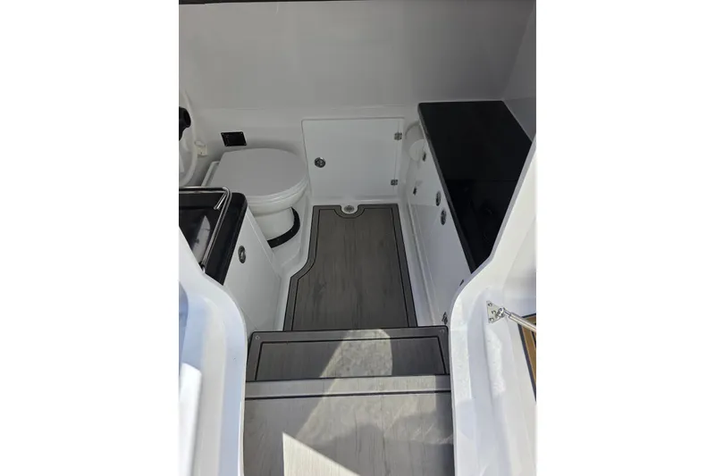 Slide: The Image of Interior of 2026 Monterey Elite 30 OB boat, featuring a compact bathroom with modern amenities. - 20