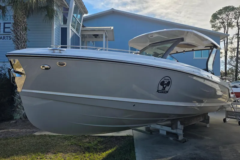 Slide: The Image of 2026 Monterey Elite 30 OB boat displayed outdoors near a modern building. - 3