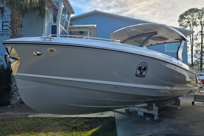 Slide: The Image of 2026 Monterey Elite 30 OB boat displayed outdoors near a blue building. - 4