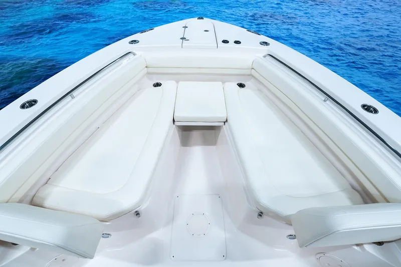 Slide: The Image of Manufacturer Provided Image: 2024 Grady-White Canyon 306 boat interior with white seating and blue ocean background. - 3