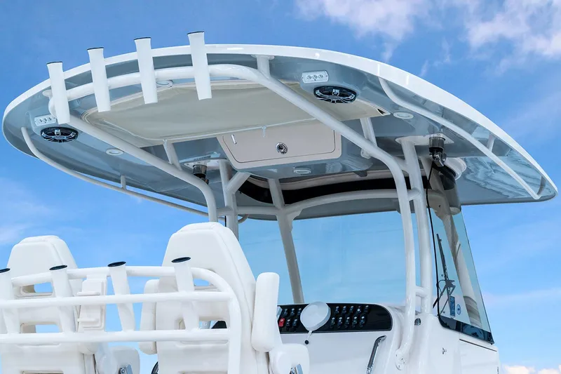 Slide: The Image of Manufacturer Provided Image: 2024 Grady-White Canyon 306 boat console and hardtop against blue sky. - 4