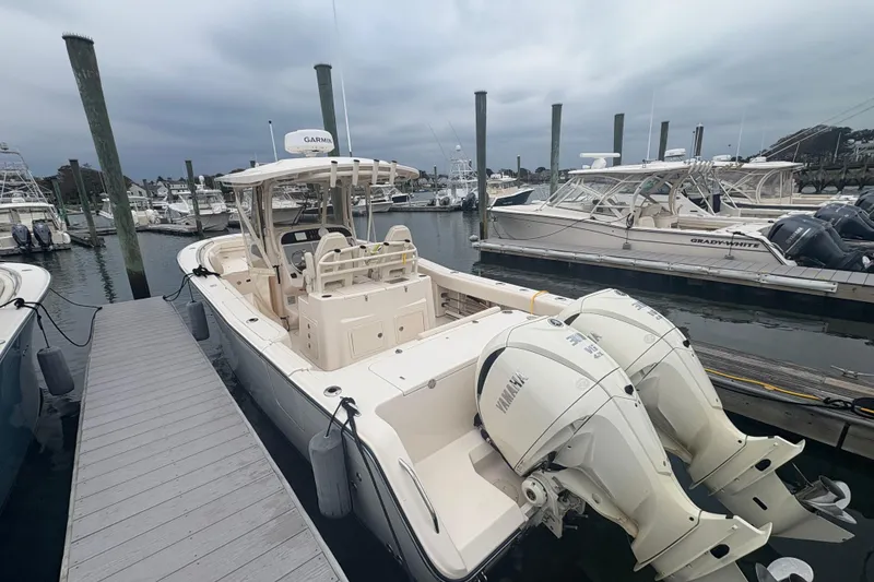 Slide: The Image of 2024 Grady-White Canyon 306 boat docked with twin Yamaha engines. - 8