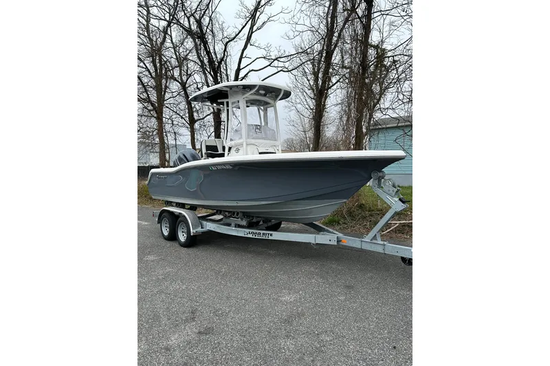 The Image of 2022 Tidewater 210 CC Adventure boat on trailer, parked outdoors. - 0