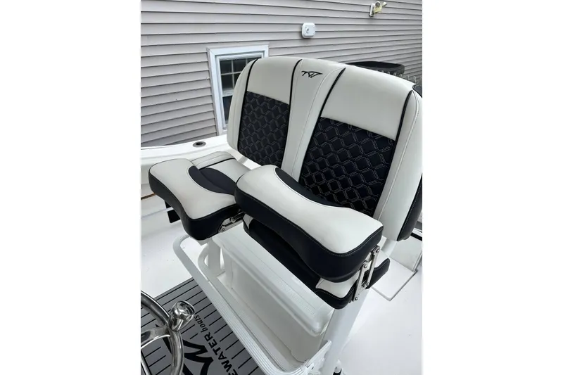 Slide: The Image of 2022 Tidewater 210 CC Adventure boat seats with stylish black and white design. - 1