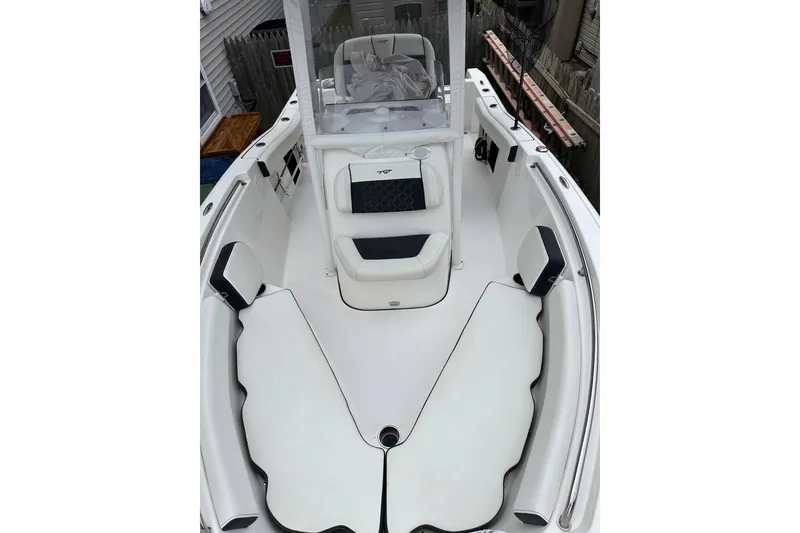 Slide: The Image of 2022 Tidewater 210 CC Adventure boat interior with cushioned seating and console. - 5